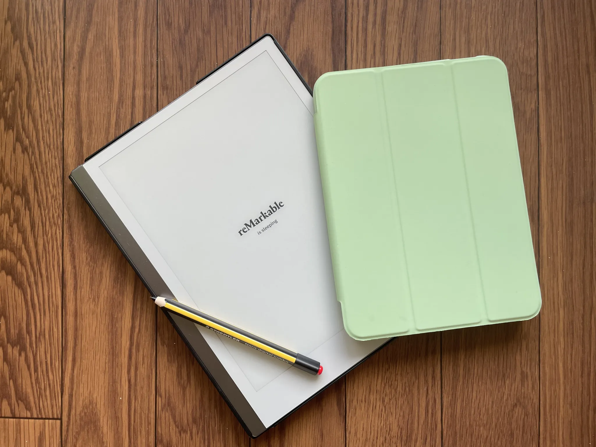 reMarkable and iPad side by side on dark wood
